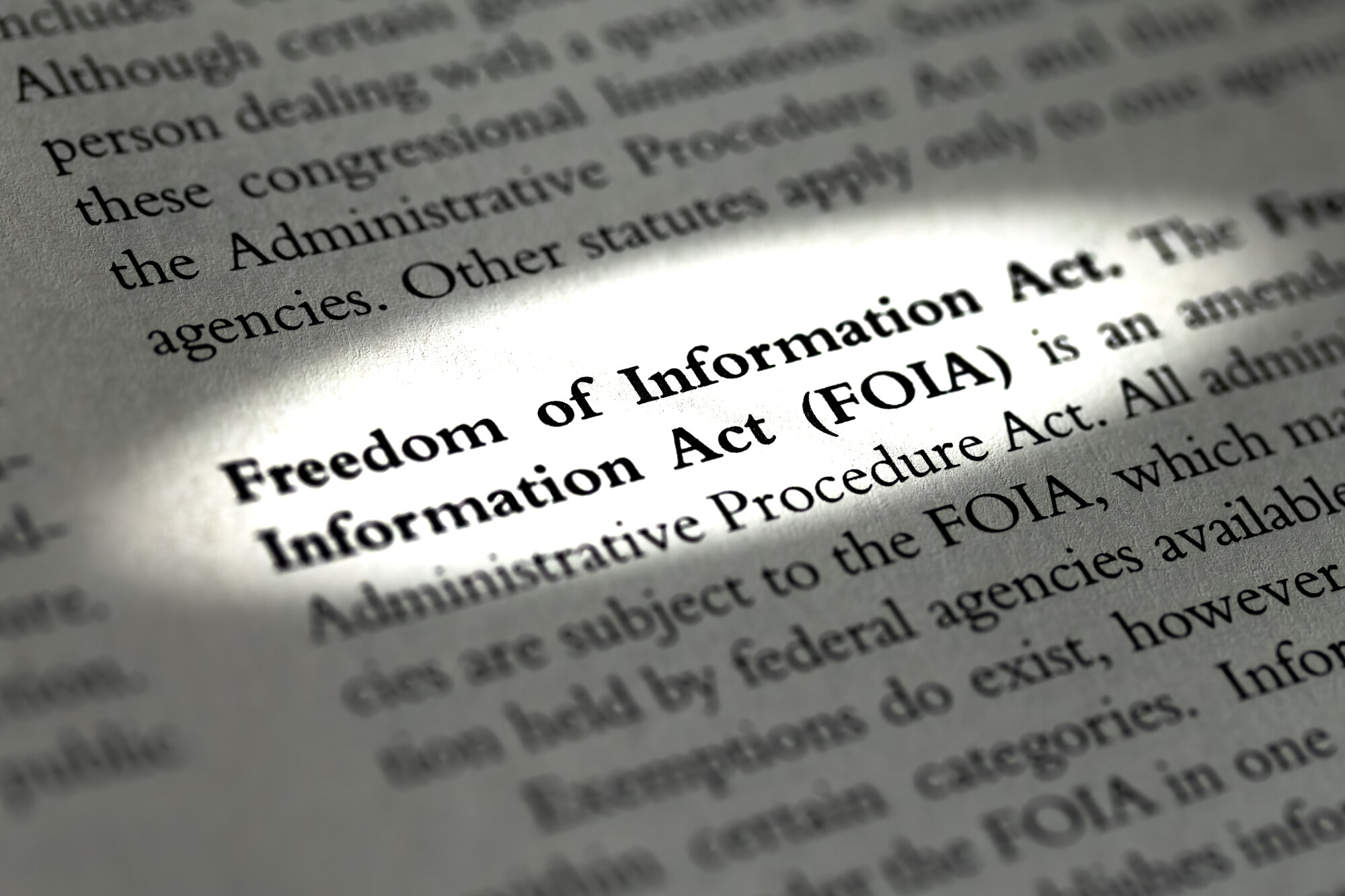 Dictionary Definition of Freedom of Information Act lighted while rest of page is darkend