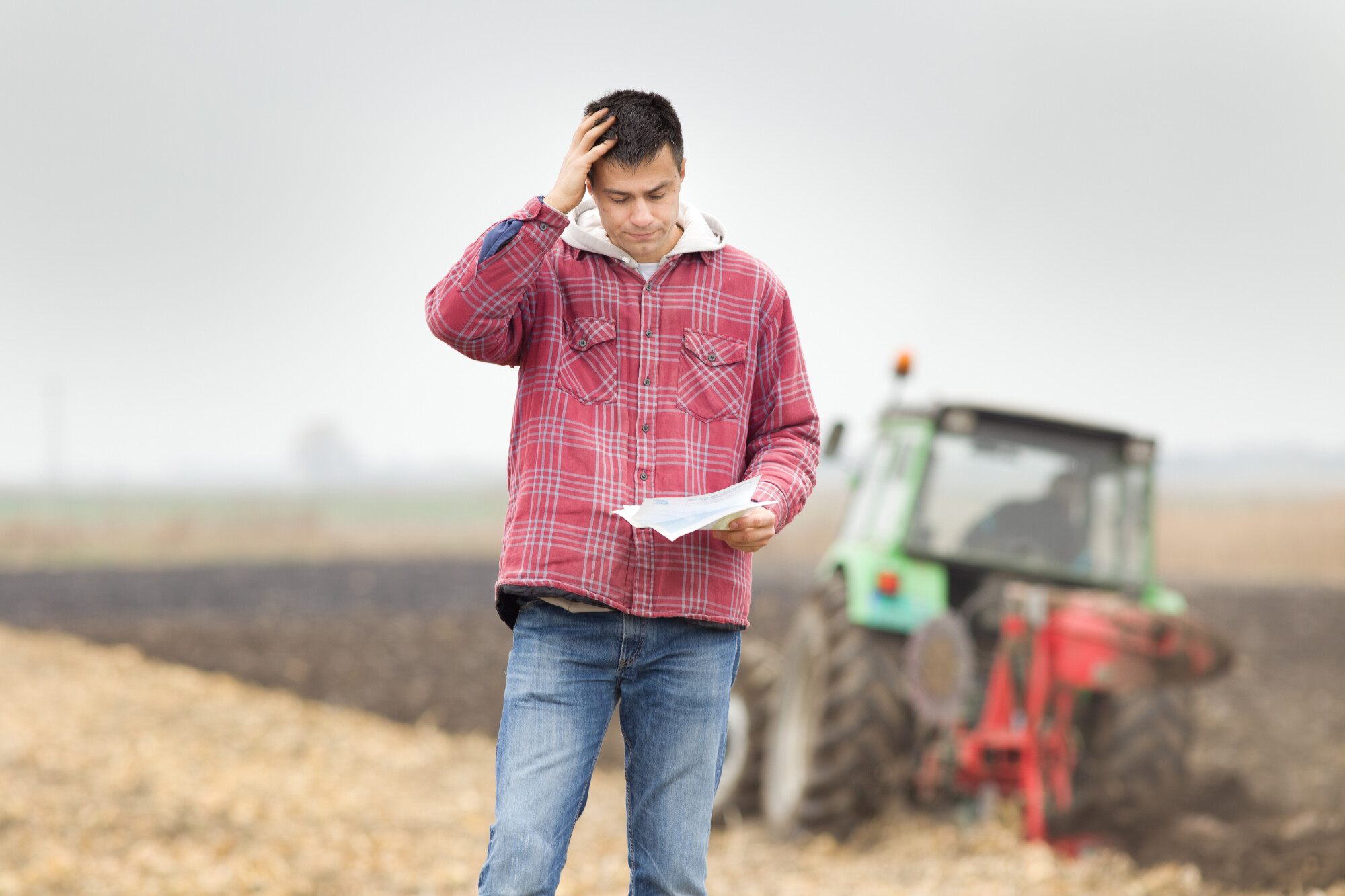 Distressed Farmer Looking at Bill