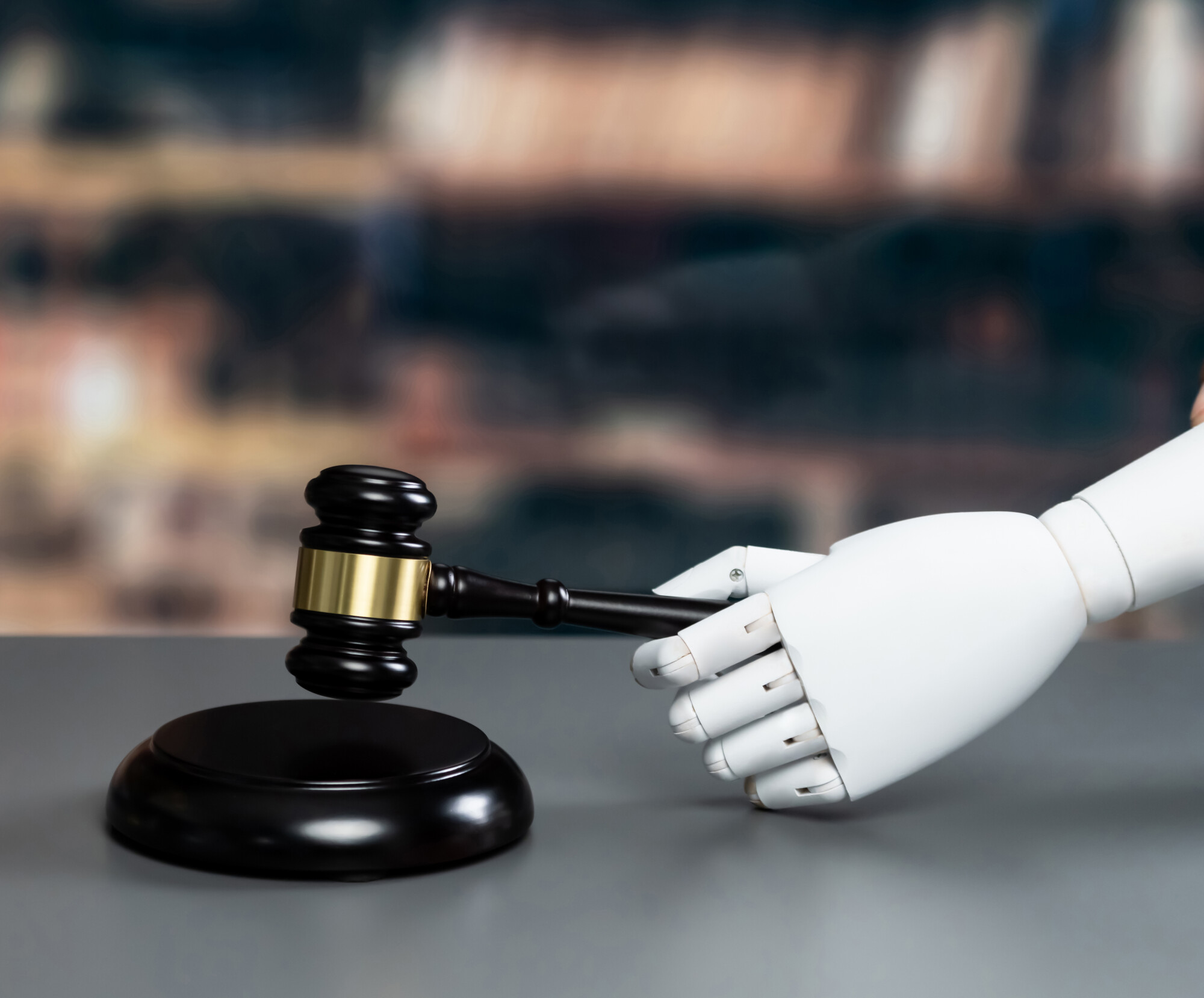 Robot hand holding a gavel