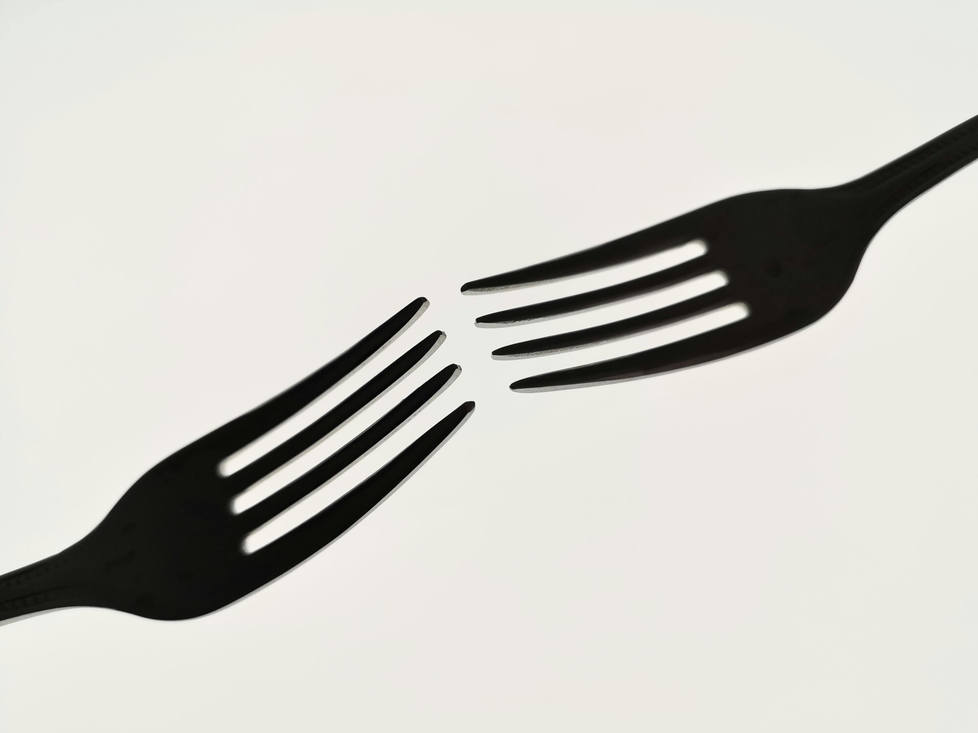 Two forks nearly touch.