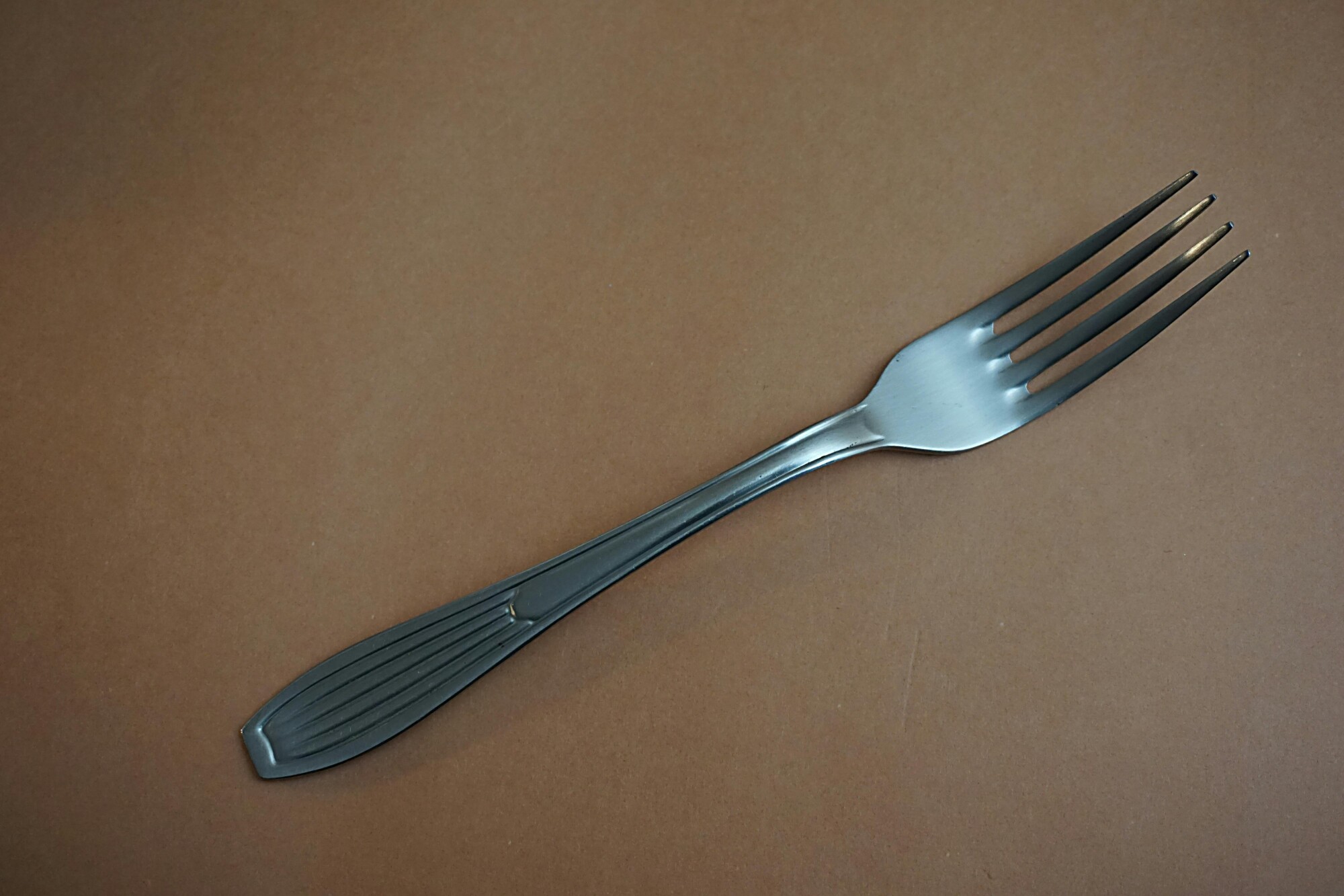 A fork sits on a table.