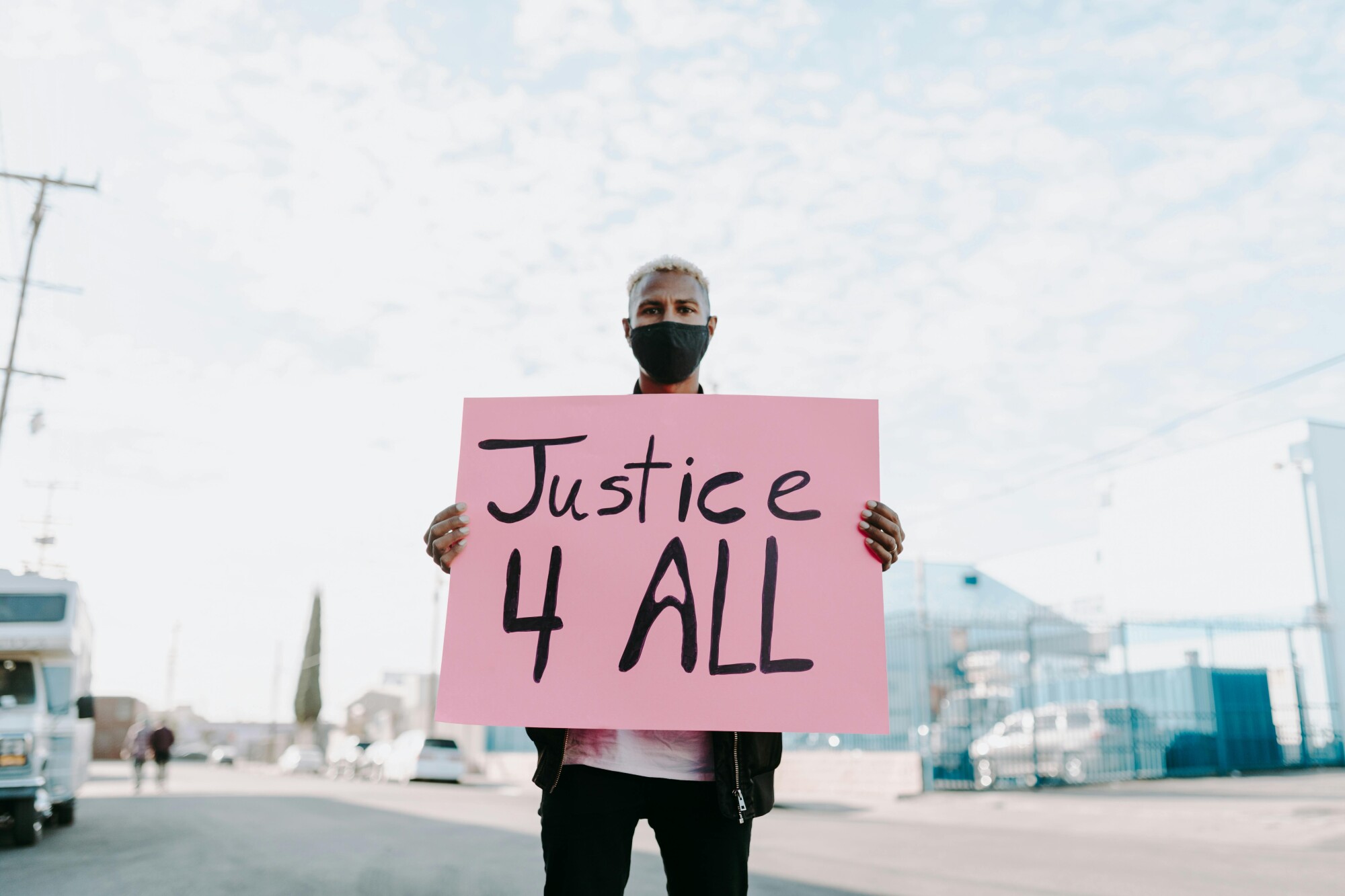 A person with a sign that says "Justice 4 All"