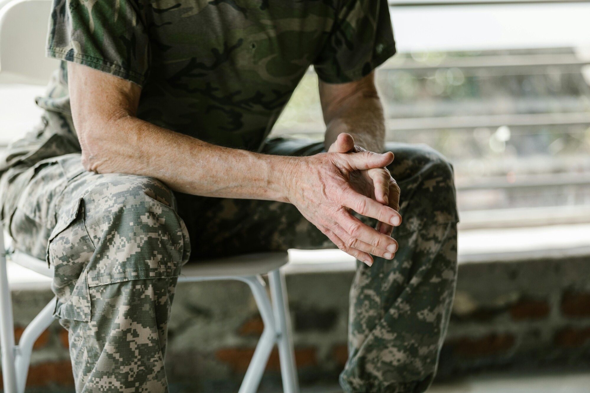 A man in a military uniform sits.